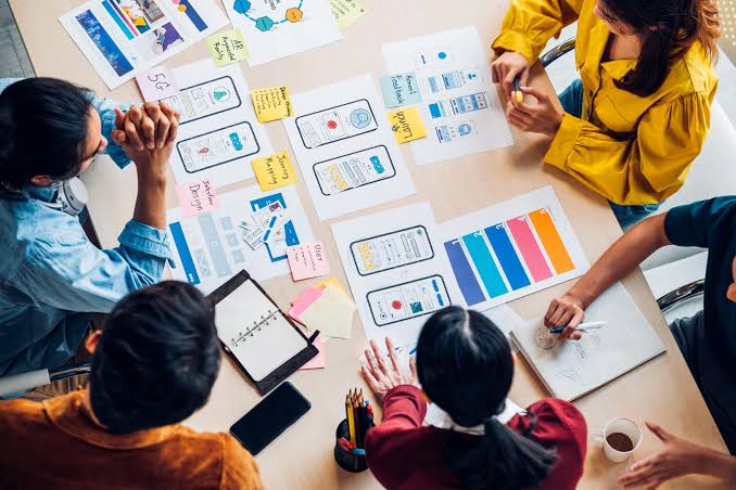 Team collaborating around a shared workspace